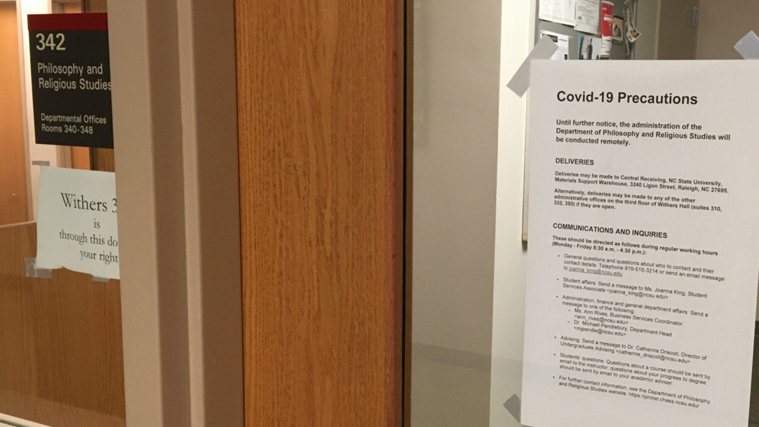 sign with COVID guidelines on door