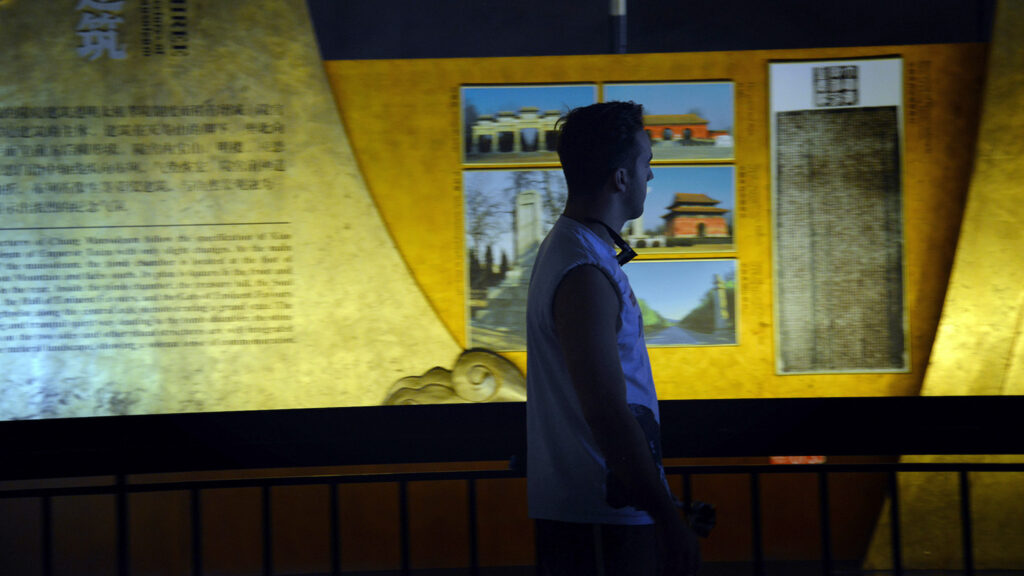 A man views a museum exhibit.