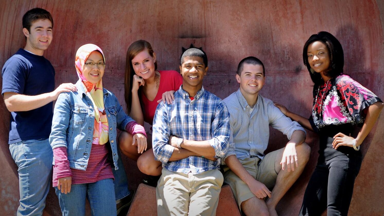 Students pose next to a statue on NC&#160;State's campus