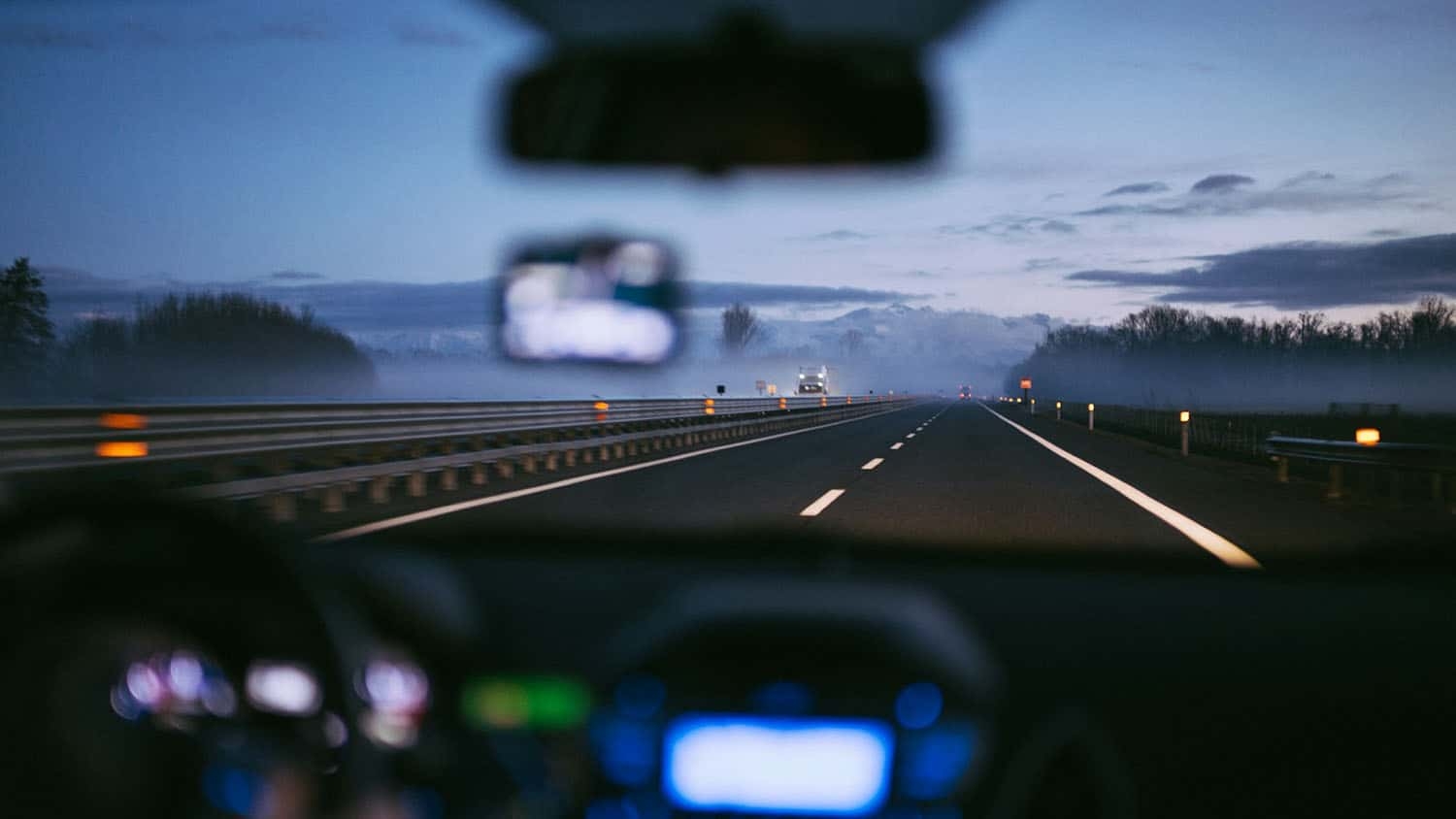 view of a highway through the windshield of a car