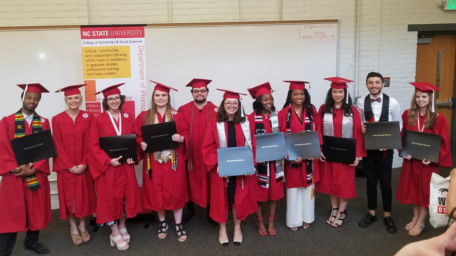 graduates dressed in caps and gowns
